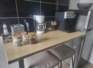 a wooden counter with a coffee maker on it at Appartement Clermont-Ferrand F3 2 chambres 1 chambre avec 1 lit simple et 1 chambre avec 2 lits doubles in Clermont-Ferrand