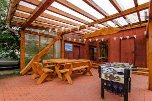 a wooden patio with a table and a stove at Smilciu 34 in Palanga