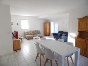 a living room with a white table and chairs at Maison récente à 450m des plages et 350m du centre ville à La Faute-sur-Mer - FR-1-194-183 in La Faute-sur-Mer