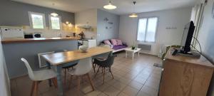 a kitchen and living room with a table and chairs at Orthe in Mugron
