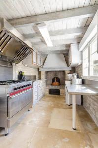 a large kitchen with a stove and a fireplace at Les 3 cepages in Balnot-sur-Laignes +22 photos