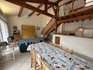 a living room with a table and a kitchen at Rose in Biscarrosse +13 photos