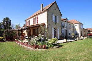 een oud huis met een tuin ervoor bij La foret in Aydie