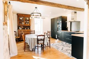 a kitchen with a table and a dining room at Le gout in Lasseubetat