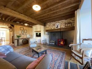 a living room with a couch and a fireplace at Le gout in Lasseubetat