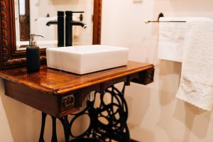 a bathroom with a white sink and a mirror at Le gout in Lasseubetat +47 photos