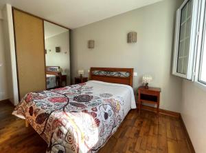 a bedroom with a bed and a wooden floor at Mendi beheria in Uhart-Cize