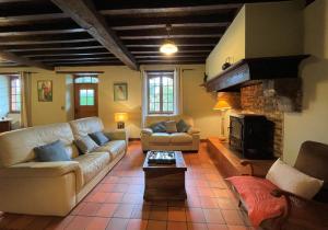 a living room with a couch and a fireplace at Aguerre in Lichos