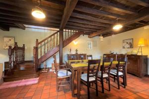 a dining room with a table and chairs and a staircase at Aguerre in Lichos