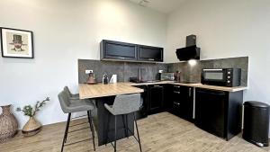 a kitchen with a counter with a microwave and a stove at Domaine de juriol - l'annexe in Le Palais-sur-Vienne