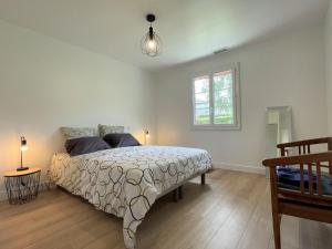 a bedroom with a bed and a window and a lamp at Gure doya in Ibarrolle +35 photos