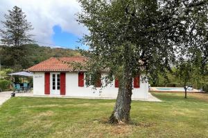 a white house with a tree in the yard at Gure doya in Ibarrolle