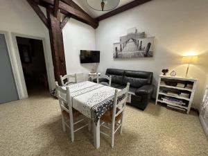 a living room with a table and chairs and a couch at Le pin franc in Azur