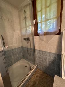 a bathroom with a shower and a bath tub at Le pin franc in Azur +8 photos