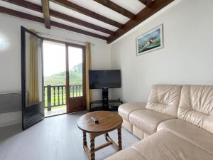 a living room with a couch and a table at Iparla in Urrugne