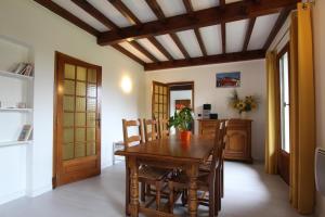 a dining room with a wooden table and chairs at Iparla in Urrugne