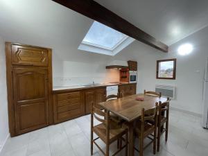 a kitchen with a wooden table and a skylight at Iparla in Urrugne +10 photos