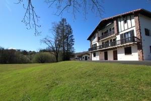 a house on a hill with a green field at Iparla in Urrugne