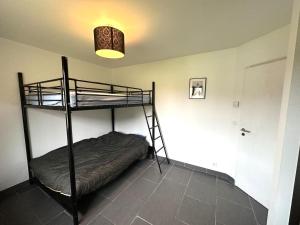 a room with two bunk beds and a light at La villa lou miqueou in Lit-et-Mixe +16 photos