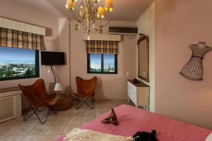 a bedroom with a bed with a cat laying on the bed at Luxury Villa Golden Crest with private swimming pool in Hersonissos