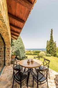 a wooden table and chairs on a patio at Luxury Villa Golden Crest with private swimming pool in Hersonissos