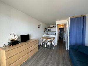 a living room with a couch and a table with a tv at Cocon côtier - Vue sur Mer - Parking - Proche de la Thalasso - Terrasse in Pornichet