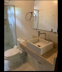 a bathroom with a sink and a toilet and a shower at Paz e amor in Matta de São João