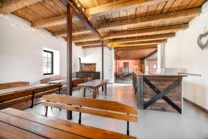 a row of benches in a room with wooden ceilings at Historická budova Třebovský mlýn v Dlouhé Třebové in Dlouhá Třebová