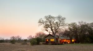 a gazebo in the middle of a field at Rhino Walking Safaris in Skukuza
