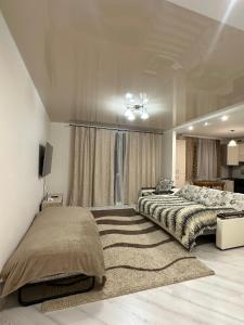 a bedroom with a large bed and a rug at Apartment Ivashchenka 1a in Luts'k