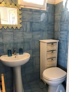 a bathroom with a toilet and a sink at Splendid cottage on Tuscan Sea in Porto Santo Stefano
