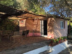 a patio with a table and chairs and a house at Splendid cottage on Tuscan Sea in Porto Santo Stefano