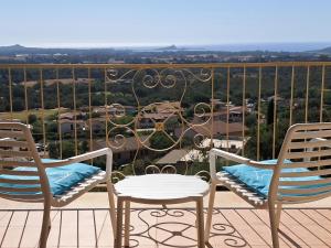 two chairs and a table on a balcony with a view at Golf & Sea Residence Is Molas in Pula