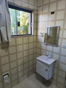 a bathroom with a sink and a mirror at 11suites casa Suite#4 in Caraguatatuba +13 photos