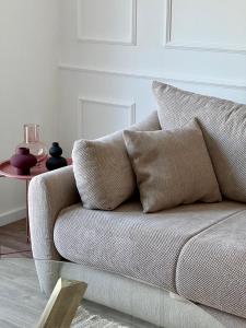 a couch with two pillows on it in a living room at Apartments Mrdak in Bar