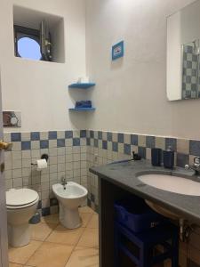 a bathroom with a toilet and a sink at Casa Marietta in Lipari +42 photos