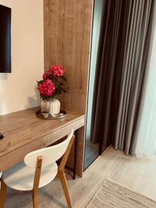 a table with a vase of flowers on top of it at Apartments Mrdak in Bar