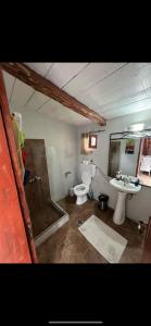 a bathroom with a toilet and a sink and a shower at Country house in nature in Heraklion