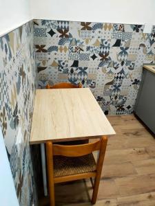 a wooden table and a chair in a kitchen at chicca in nature near florence in Pratolino