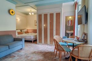 a living room with a couch and a table at Aparthotel AMMI Vieux Nice in Nice