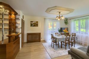 a kitchen and dining room with a table and chairs at Apartament U Jagody in Tylicz
