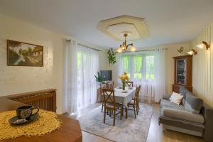a living room with a table and a couch at Apartament U Jagody in Tylicz