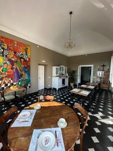 a dining room with a table and a painting on the wall at Villa del Parco in Poggi +46 photos