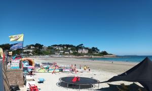 a beach with a playground and people on the beach at Studio belle vue in Trévou-Tréguignec