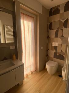 a bathroom with a toilet and a sink and a mirror at Leila's Home in Gaeta +12 photos