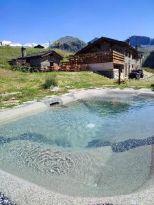 a large pool of water in front of a building at Rifugio Baita Belvedere in Champoluc