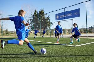 a group of young boys playing a game of soccer at Sani Club in Sani Beach
