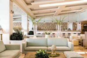 a lobby with two couches and a bar at Sani Club in Sani Beach
