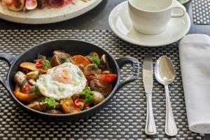a pan of food with an egg on a table at Sani Club in Sani Beach