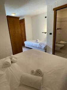 Letto o letti in una camera di Rifugio Baita Belvedere